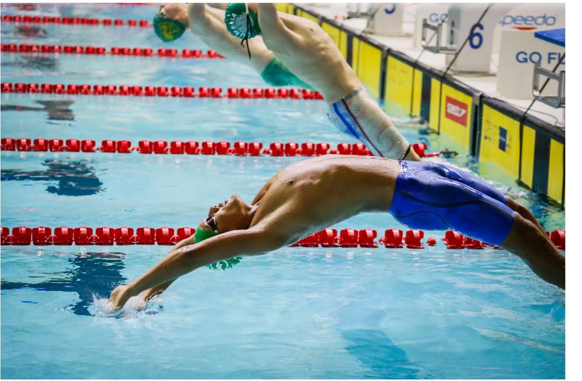 Grantham Swim Club swimmer launching into a backstroke start at a championship gala