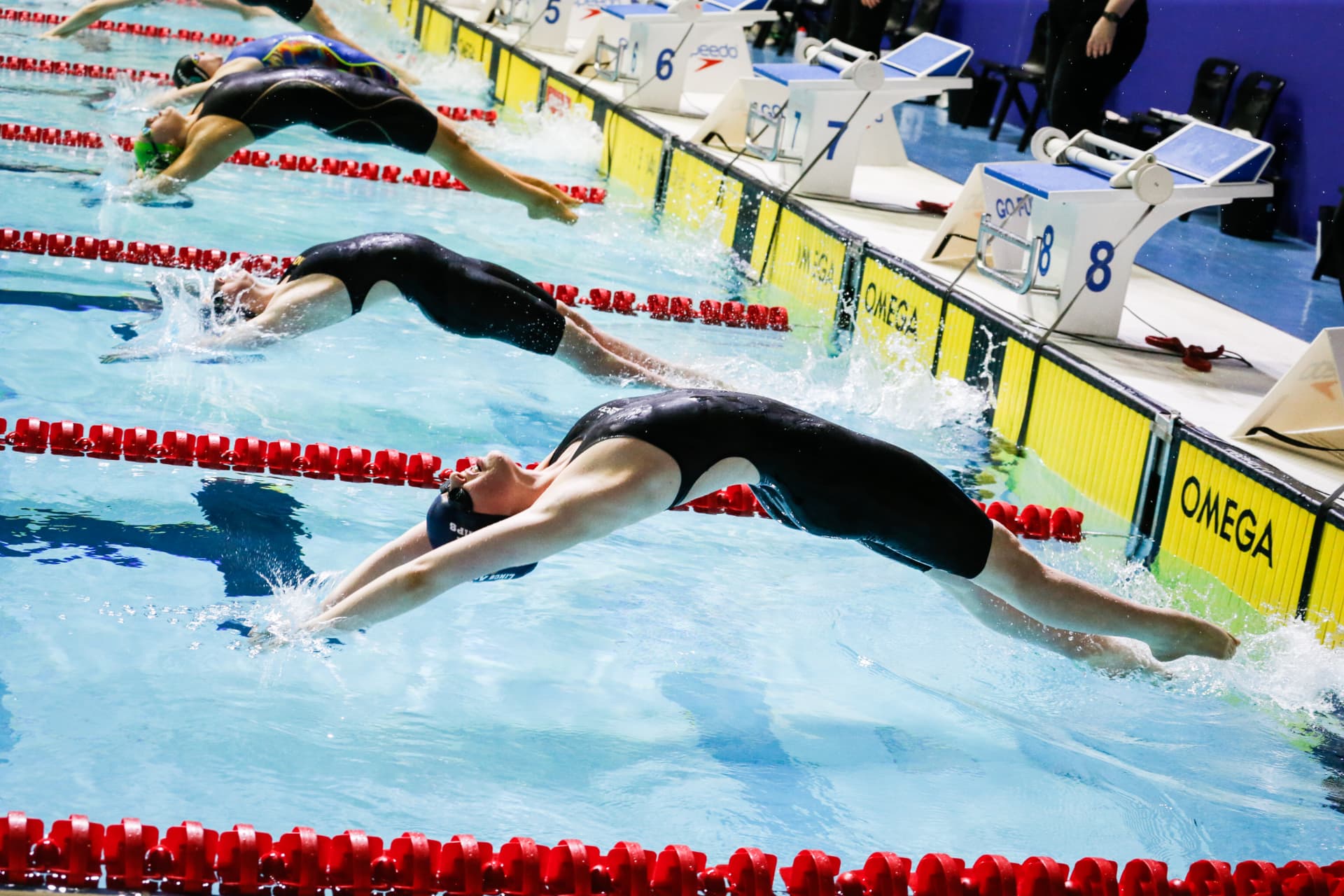 Grace Macdonald at the start of a backstroke race